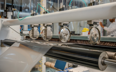 Industrial roll-to-roll replication and lamination of holographic optical films for in-plane HUD systems.